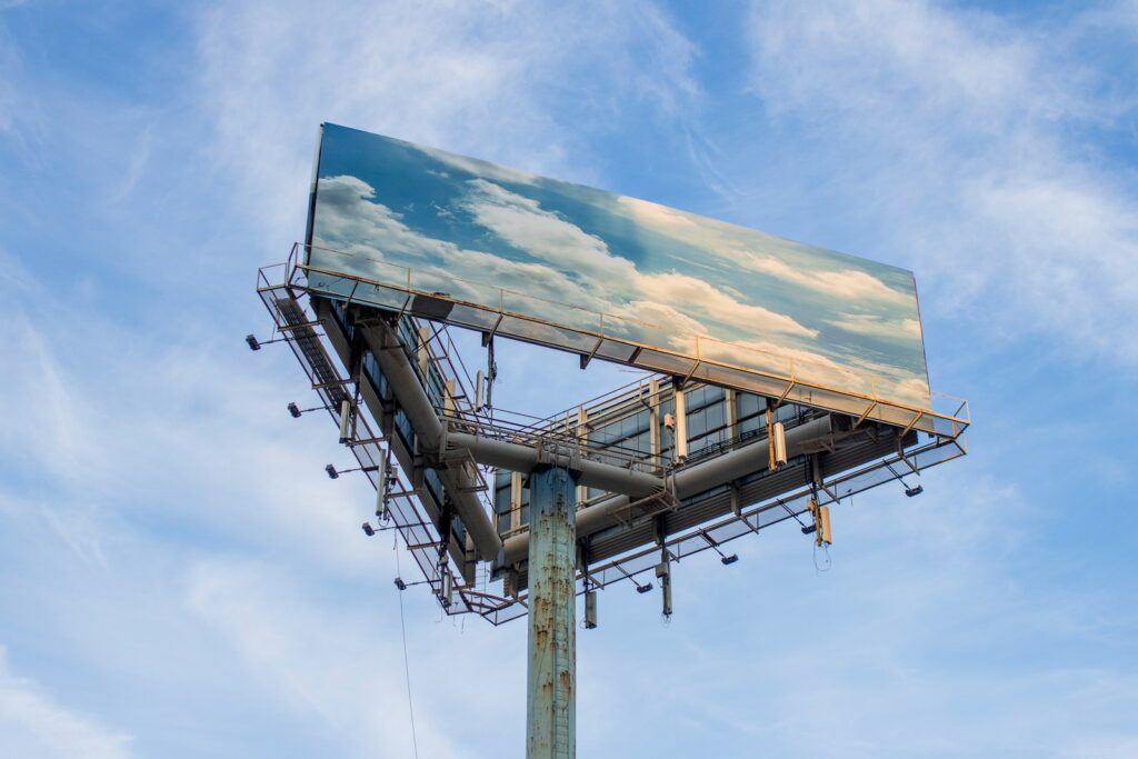 Large-format billboard hoarding structure against sky